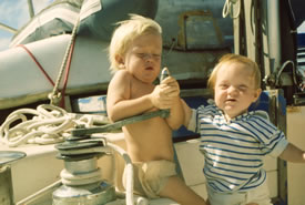 Two boating babies playing with a winch