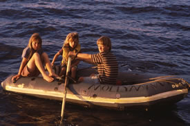 Three children rowing an Avon dinghy